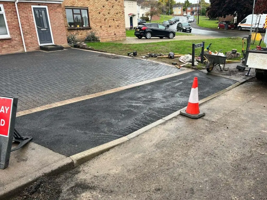 dropped kerb at front of driveway finished with tarmac